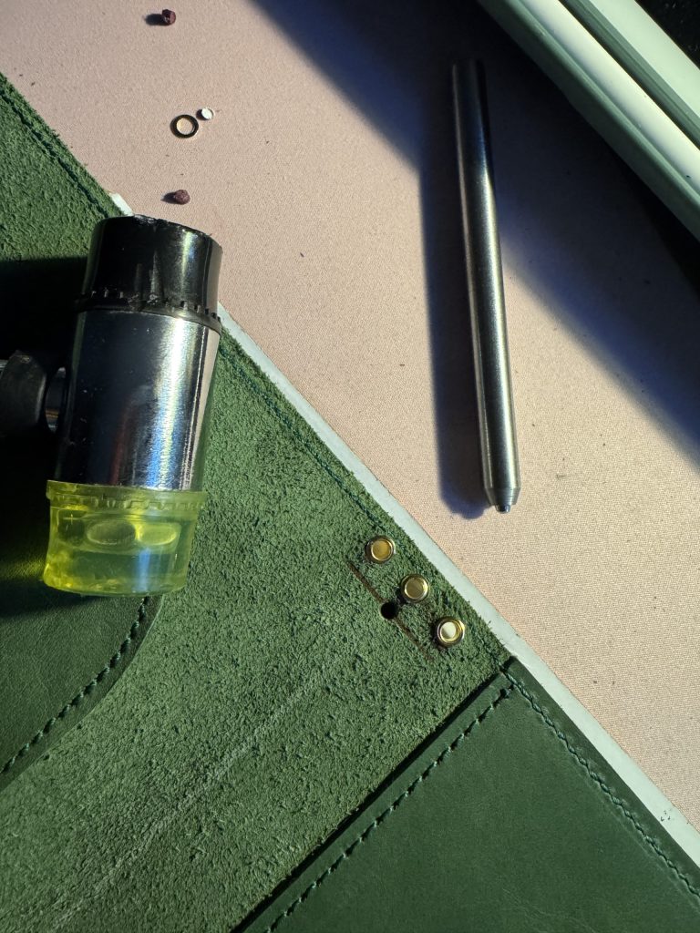 olive leather folio inserting grommets - FORTÉ x Penelope leather folio collaboration