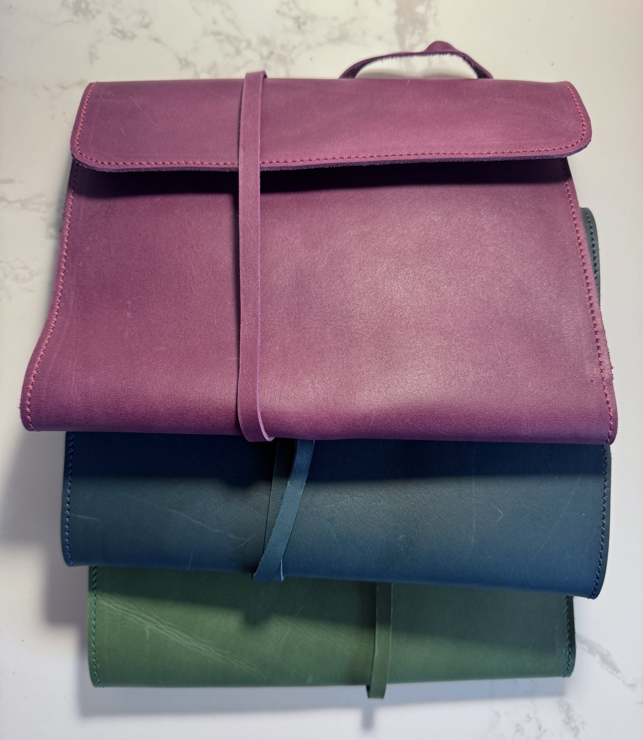 plum leather folio stacked - FORTExPenelope plum leather folio stacked - FORTÉ x Penelope leather folio collaboration